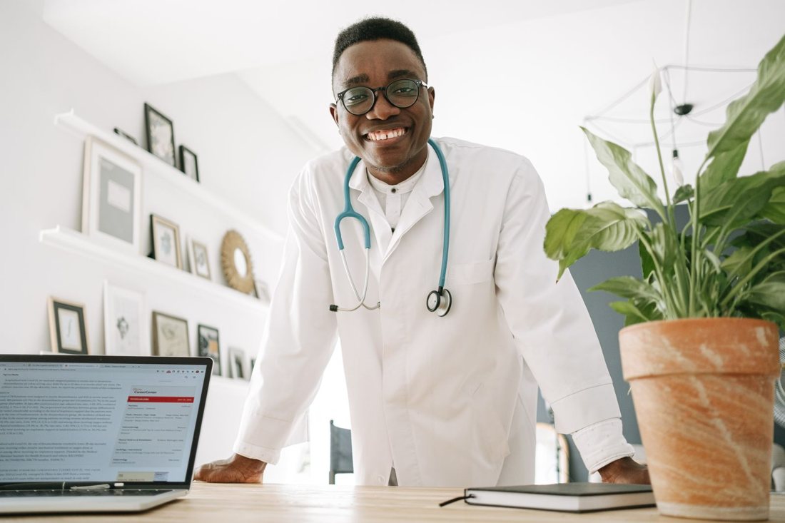 Smiling physician in his office